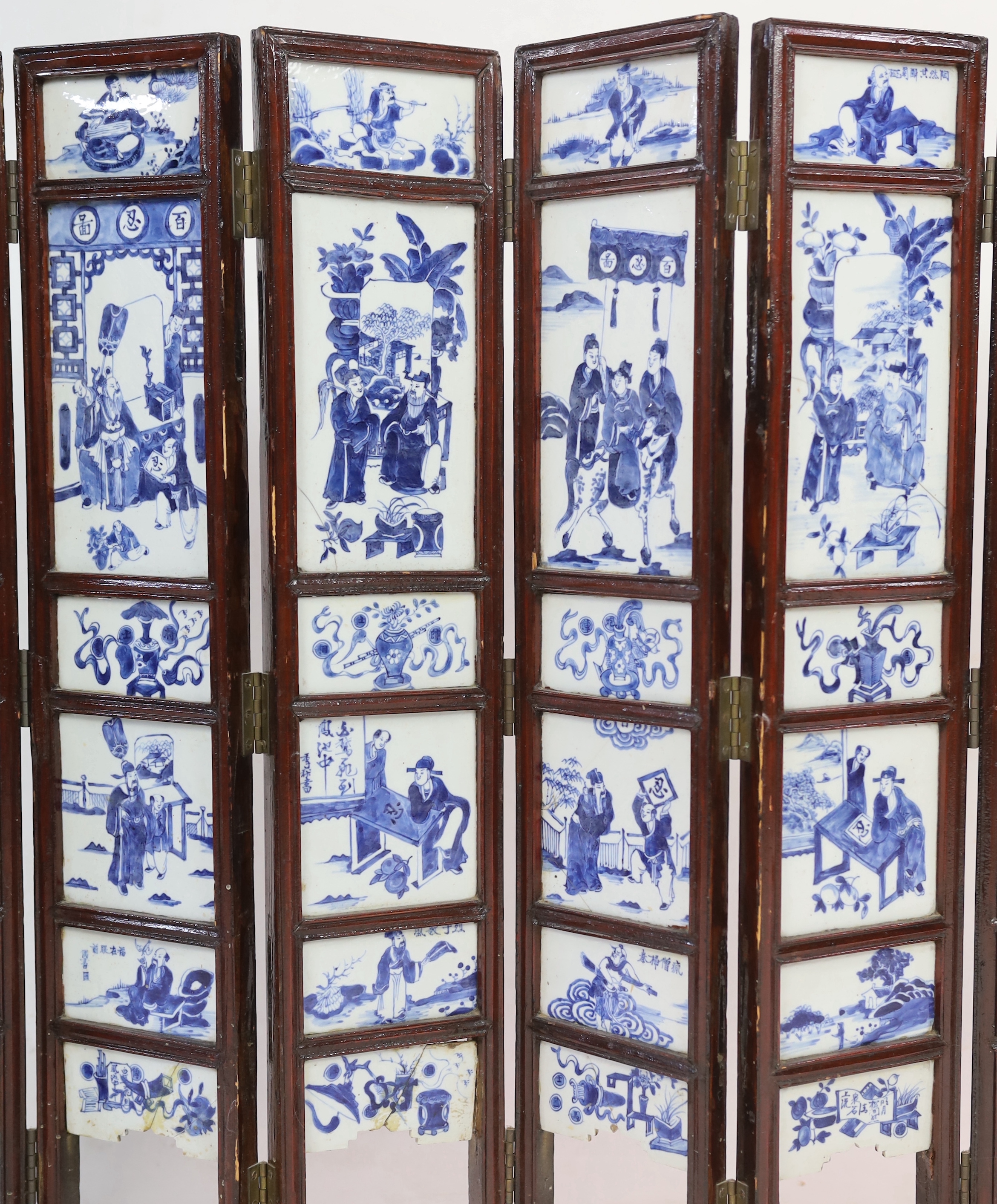 A Chinese blue and white panelled seven-fold low screen, late 19th/early 20th century, some cracked panels